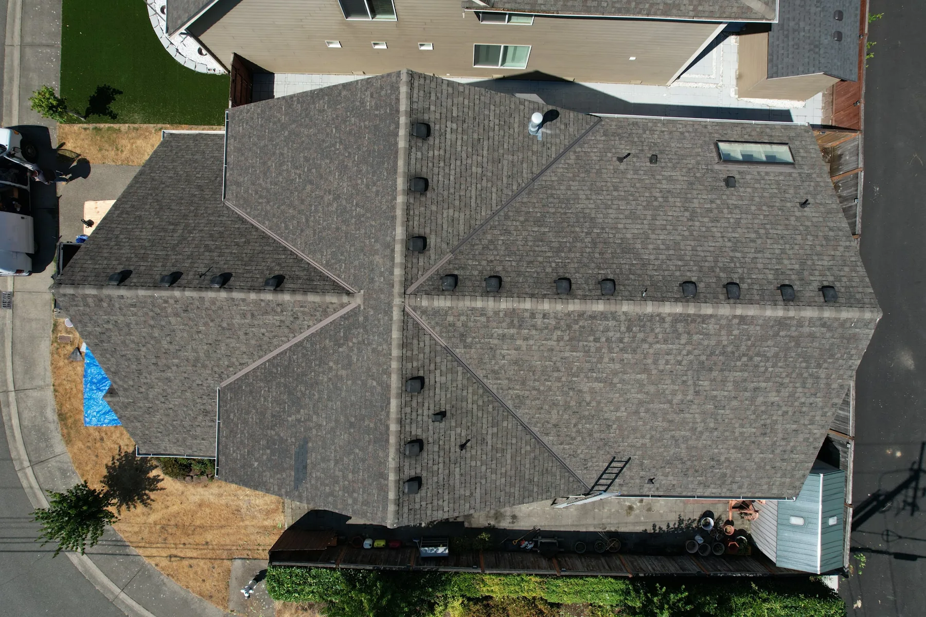 Aerial view of a worn asphalt shingle roof before Titan Roofing's replacement