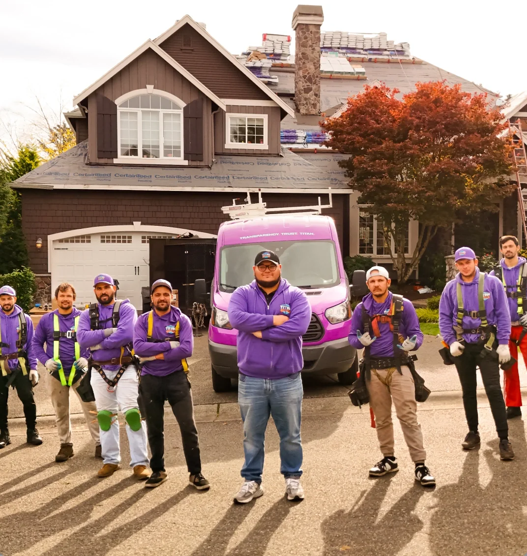 The Titan Roofing team in front of the company van