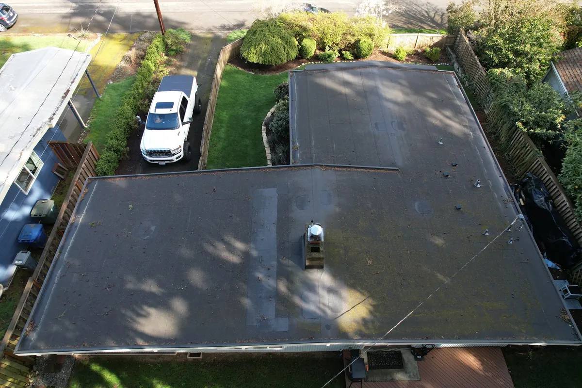 Before: Flat roof to white TPO membrane