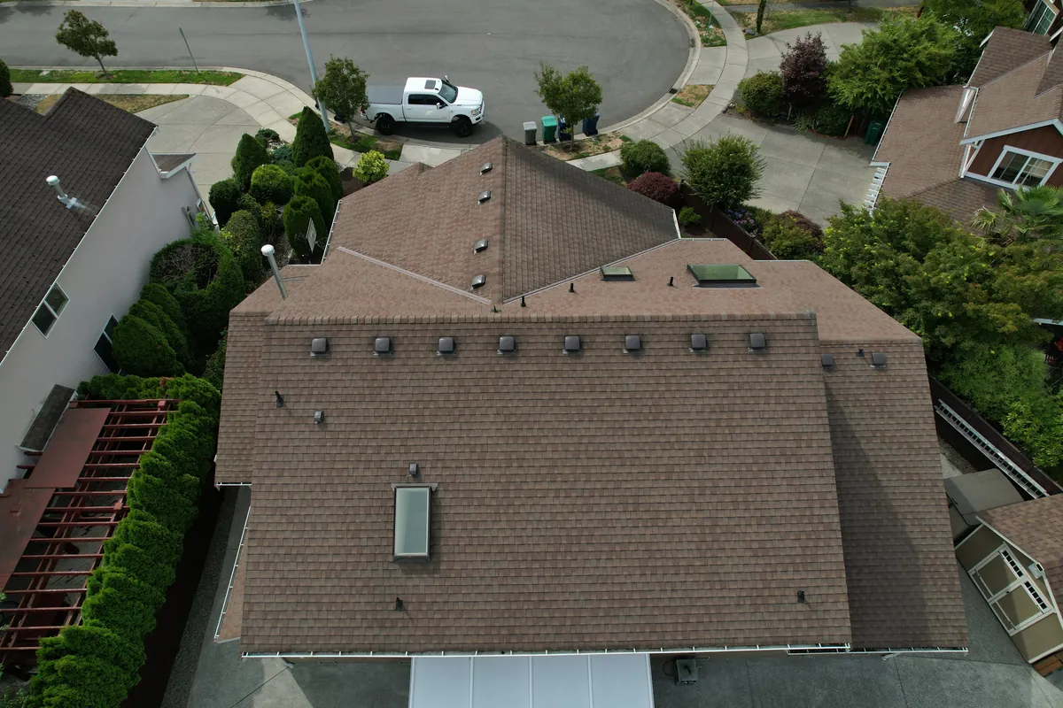 Before: Brown shingles to a charcoal architectural roof