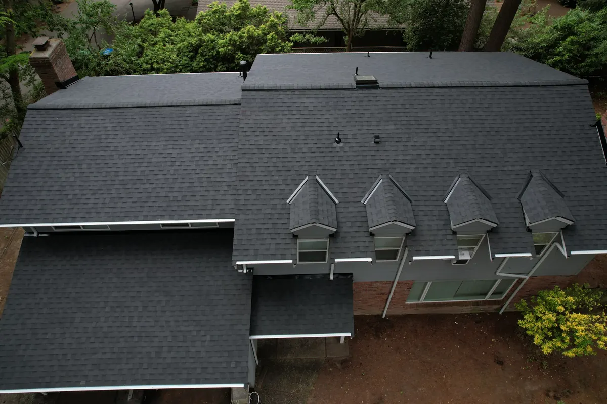 After: Damaged shingles to a new charcoal roof