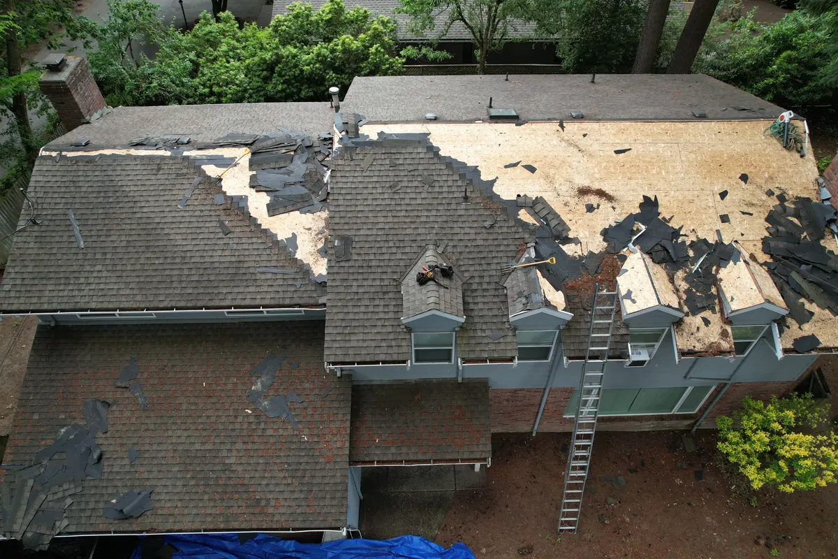 Before: Damaged shingles to a new charcoal roof